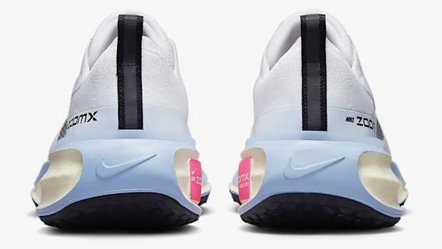 Rear view of white and blue Nike shoes.